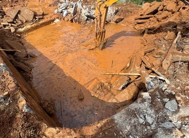 excavator digging out concrete pool