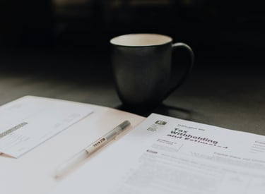 Tax documents and a cup on the table 