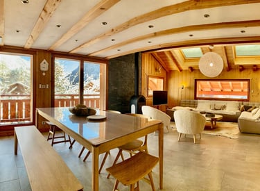 a dining room with a table and chairs