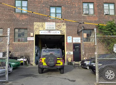 a car parked in front of a building with a fire hydrant