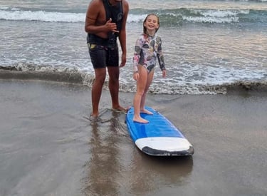 a woman and her daughter standing in the water