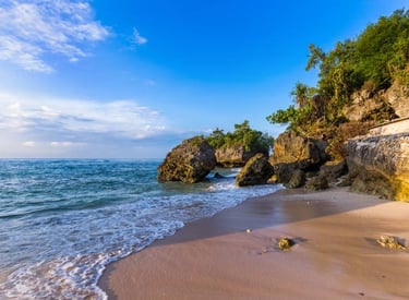 Padang Padang Beach with a rocky shore and a blue sky