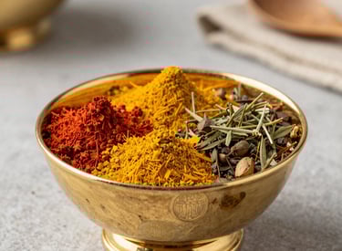 Three trays of golden-brown battered fish and crispy fries are arranged on a red table. A person in a plaid shirt is reaching for some of the food. Small containers of dipping sauce are placed beside the plates.