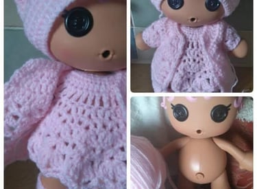 a doll doll with a pink crochet outfit and a pink hat made to measure