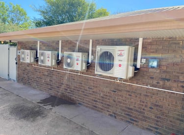 multiple split system air conditioner outdoor units mounted on wall brackets with dedicated sub boar