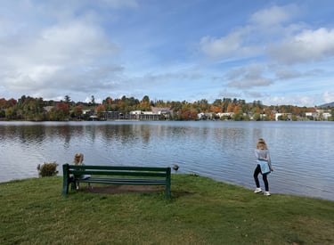 Two girls admire the landscape of Mirror Lake in Lake Placid in autumn