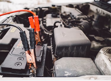 a car battery charger jump starting a car battery