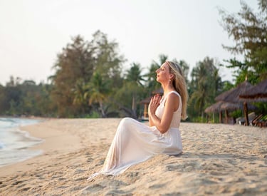 Woman sitting on the beach during a sunset personal branding photoshoot in Phu Quoc