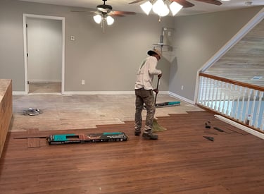 Professional work on the installation of flooring in a modern apartment.