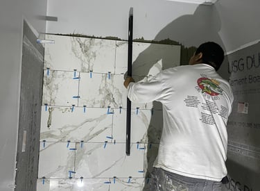Professional working on a bathroom remodel installing marble