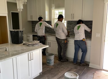 a group of people standing in a kitchen