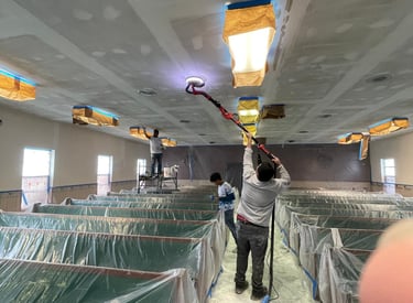 Workers preparing the church ceiling with a sander, to be painted.