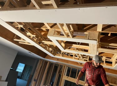 professional carpenter working on a wooden structure inside a room.