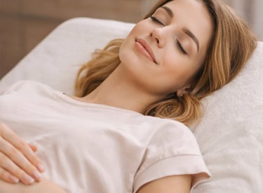A woman relaxing with her eyes closed during a professional facial treatment