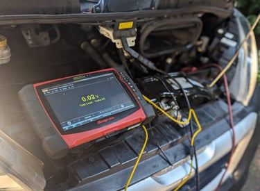 a car with a battery and a battery in the trunk of a car