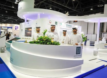 Event Photogrphy Dubai - a group of men standing in front of a large white counter