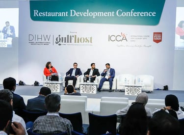 a group of people sitting in chairs at a conference