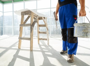a man in blue overalls and a bucket hat
