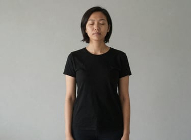 A bottle of mineral supplement labeled 'Magne-Granat' sits on a wooden cutting board. Beside it, a halved orange and sprigs of rosemary add a touch of natural freshness. The background features a light, textured wall.