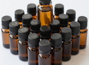 A person is sitting cross-legged on a yoga mat, holding a purple container with a white lid in their hands. A dropper bottle and a smartphone are placed next to them on the mat.
