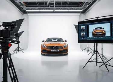 a car in a studio with a camera and a camera