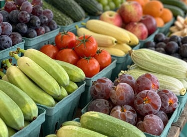 A group of people appears to be participating in an outdoor fitness class or dance session. They are dressed in athletic clothing, and a blue banner can be seen in the background, along with a stage. The setting suggests a lively and energetic atmosphere.