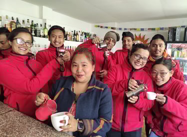 a group of baristas standing around a counter top