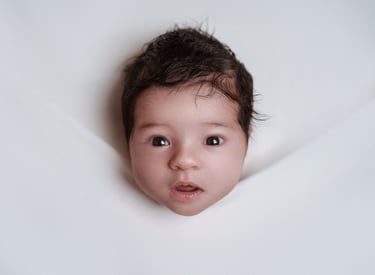 a baby girl with a big smile on her face, photoshoot at the customer's home address