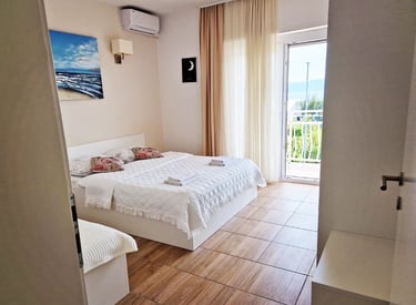 room with a bed, cabinet and windows