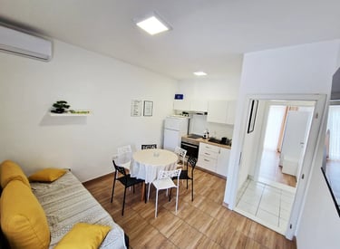 a kitchen and dining room with a table and chairs