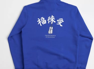 Nike SB x Fly Streetwear 1/2 zip fleece in royal blue with white accents, featuring co-branded chest logo and 'The Fragrance 