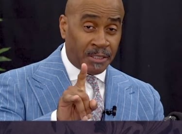 Gino Jennings of Truth of God Broadcast showing hand signs at the FCOOLJC on July 13 2025