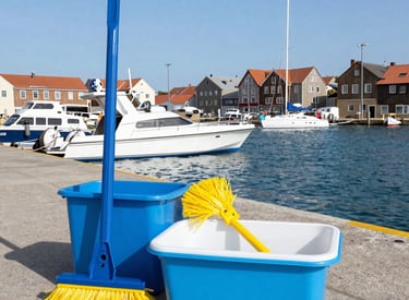 A professional cleaner in navy uniform carefully removing debris from a freshly built industrial site under bright daylight.