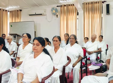 a group of people sitting in chairs in a room