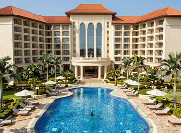 A serene beachfront resort at sunset, with golden light reflecting on calm waves and palm trees swaying gently.