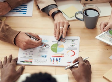 data visualization of a pie chart being analyzed by people 