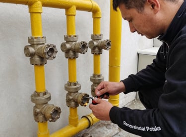 Technician checking gas pipes and connections in a clean, well-lit utility room