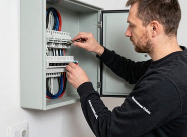 Electrician installing wiring in a modern residential building with precision and care