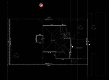 Detailed architectural site plan showing house footprint, driveway, and property dimensions.