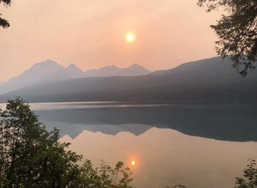 smoky haze over a mountain range with sun