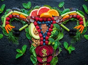Fresh fruits and vegetables arranged in the shape of a female reproductive system for reproductive health.