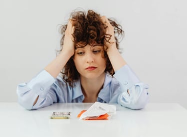 a woman sitting at a table with a lot of money