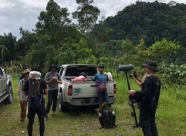 a group of people standing around a truck while shooting 