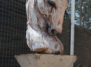 "Hand-carved wooden horse head sculpture by Axel Atelier, mounted on an inverted geometric concrete