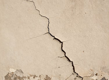 Restored wall showing repaired cracks and fresh paint in a modern style.