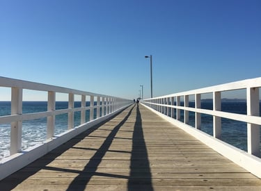 A single point persective looking down a pier