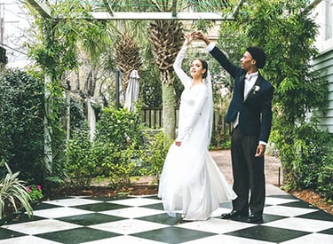 a bride and groom standing in front of a gazeboar