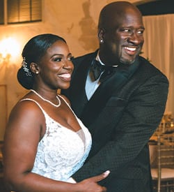 a man and woman standing in front of a table