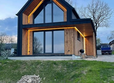 a house with a large window and a car parked in front of it