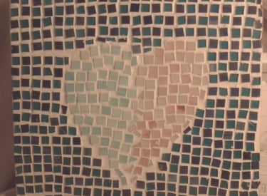 Handmade mosaic tile art featuring a light blue and pink heart on a dark blue square background.